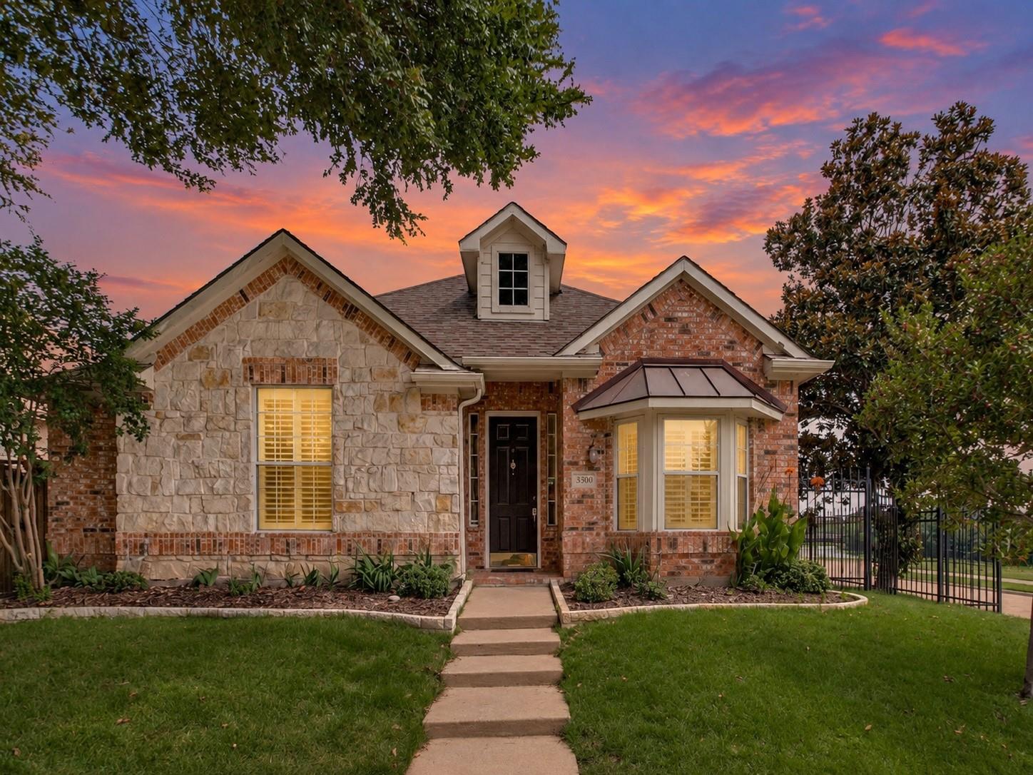 Front exterior of 3500 Christopher Lane with a two-car garage and landscaped lawn