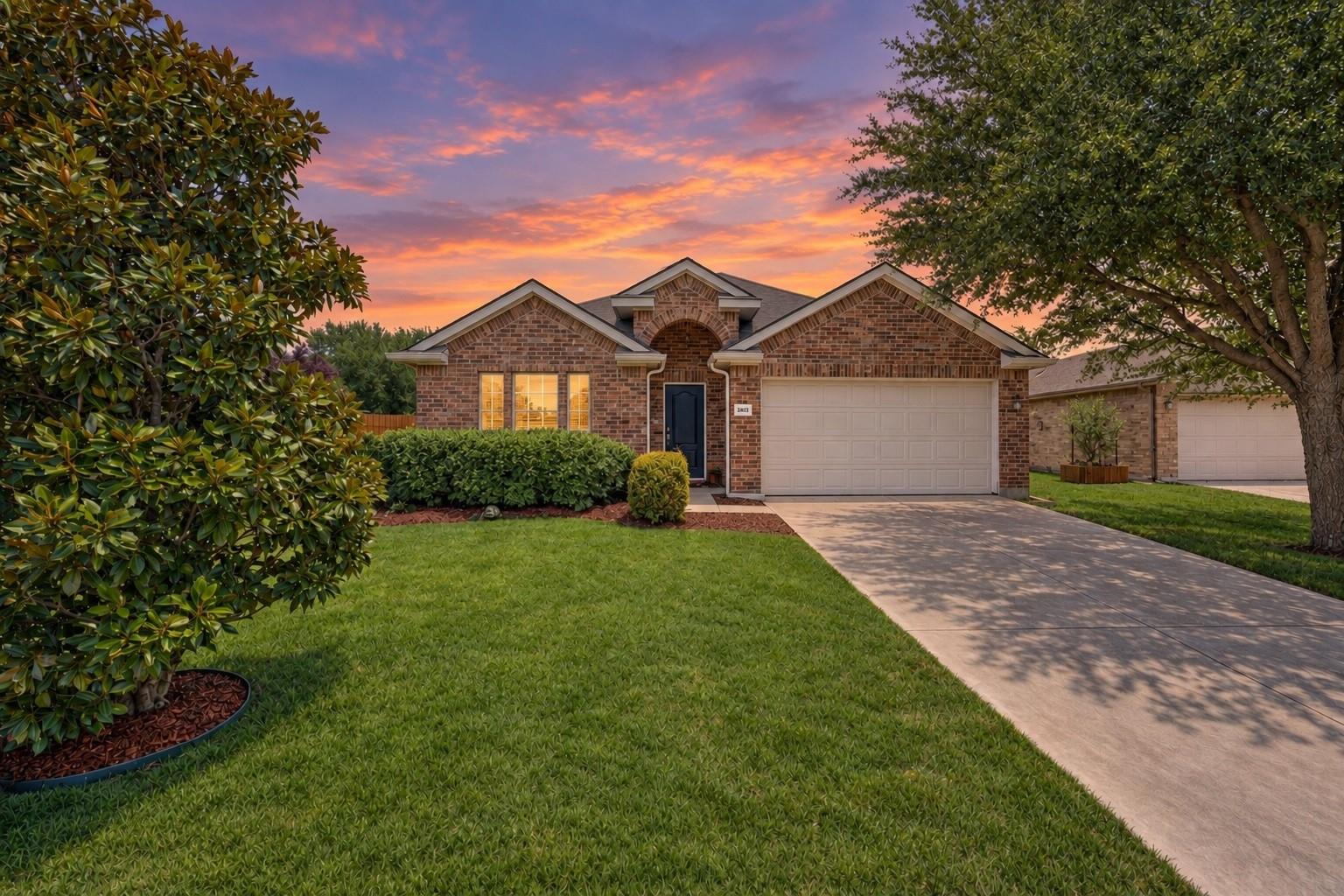 Front exterior of 2216 Julian Drive with a two-car garage and landscaped lawn